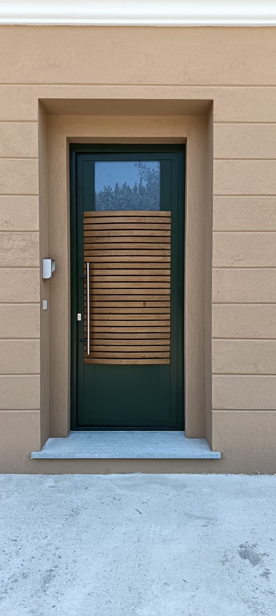 Portoncino verde con l'inserto in doghe in legno curvate